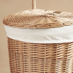 a wicker basket with a white cushion on top