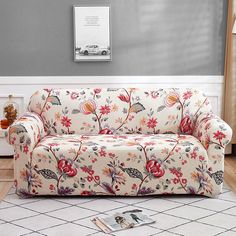 a living room with a floral couch and rug