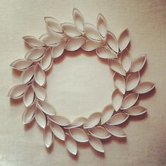 a paper wreath made out of leaves on a table