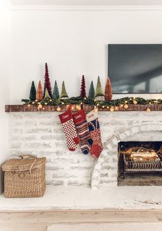 stockings hung on the fireplace with christmas decorations