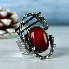 Handmade sterling silver ring with natural red coral stone. Red stone ring for women and girls. Oval shape ring with red color gemstone. Armenian handmade jewelry by Shahinian Family. This Unusual ring seems to come from  Space) If you are fond of unique and exclusive jewelry, this set can be a great idea. Be different Give and get only high-quality, not mass-produced, and unique jewelry. Your jewelry introduces you before you even speak  FULL DETAILS】 ► Gemstone: Natural red coral cabochon ► RING size: all sizes are available (choose from the option) ► Ring Weight: approx. 12 gr ► Earrings weight: approx. 13 gr ►Earrings length without hook: 34 mm (with hook 52 mm) ► Stone size: 10 mm / 8 mm More from us For more gemstone rings, click here: https://etsy.me/3s2cHOi For more earrings, click Red Oval Rings With Natural Stones, Red Sterling Silver Ring With Natural Stones, Artisan Red Sterling Silver Rings, Artisan Red Ring Jewelry, Red Sterling Silver Rings With Natural Stones, Handmade Red Oval Cabochon Jewelry, Red Oval Moonstone Ring For Gift, Oval Red Moonstone Ring Gift, Elegant Red Rings With Natural Stones