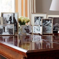 a table topped with pictures and flowers on top of it