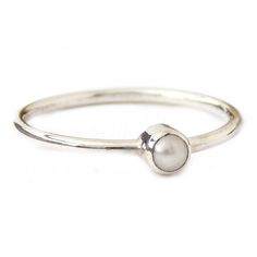 This Mini Freshwater Pearl Ring is made from sterling silver and set with a 3mm white, pink, or black real freshwater pearl. The pearl is tube set with a plain band for a minimalist design. This petite ring is perfect for stacking and makes for and excellent Valentine's Day, Mother's Day, bridesmaid, or anniversary gift. It's small, simple, modern and literally perfect for any occasion.Pearls are known as a birthstone for June. Solid Sterling Silver 3mm White Freshwater Pearl Stackable White Gold Pearl Ring With Round Band, Stackable Pearl Ring In White Gold With Round Band, Minimalist Stackable Adjustable Pearl Ring, Adjustable Stackable Minimalist Pearl Ring, Minimalist Pearl Stackable Jewelry, Minimalist Everyday Pearl Ring With Round Band, Dainty Sterling Silver Pearl Ring For Everyday, Minimalist Stackable Pearl Jewelry, Adjustable Everyday Pearl Drop Rings