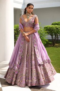 Lavender A-line flare lehenga, accentuated with all over sequin, cutdana, beads and crystal embellishments in floral bloom pattern. Paired with a plunging V neckline blouse, highlighted with all over floral bloom embroidery in sequin embellishments. Comes with a scallop trim cutwork dupatta.
Component: 3
Pattern: Hand Embroidered
Type Of Work: Sequin,Flower,Cutdana,Beads,Crystals
Neckline: Plunging V Neck
Sleeve Type: Sleeveless
Fabric: Silk, Satin Organza
Color: Purple
Other Details: 
Four side Purple Lehenga Bridal, Lavender Lehenga, Engagement Dress For Bride, Purple Lehenga, Heavy Lehenga, Chic Prom Dresses, Indian Outfits Lehenga, Floral Lehenga, Organza Lehenga