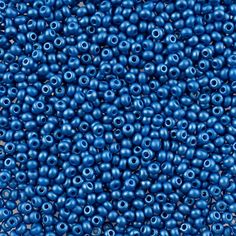 many blue beads are arranged together on the surface