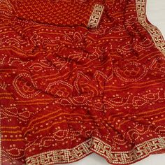 Red color saree is made from chiffon is highlighted with beautiful foil printed with printed with embroidered border work as shown. Comes along unstitched embroidered banglori silk blouse piece which you can customise as per your design/style. Occasion - You can wear this saree for festive and functions. Note:- The actual product may differ slightly in color and design from the one illustrated in the images when compared with computer or mobile screen. Measurements: Saree : Chiffon : 5.5 Mtrs Blouse : Chiffon : 0.8 Mtr Material: Chiffon Stitch Type: Unstitched Country of Origin: India Care Guide: Dry Clean Red Color Saree, Saree Chiffon, Blouse Chiffon, Embroidered Border, Mobile Screen, Chiffon Saree, Foil Print, Blouse Piece, Surprise Gifts