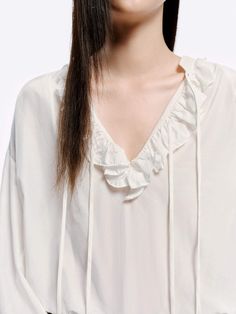 MO&Co. Women's Loose Ruffled Trim Blouse Crafted from a blend of cotton and silk, this blouse features billowy sleeves with delicate ruffled cuffs and a V-neckline with a self-tie design. The loose silhouette pairs perfectly with high-waisted jeans for a chic, effortless look. Features : - Flowy regular fit- Volume sleeves with ruffled cuffs- V neckline with self-tie straps and ruffles details- Made a silk and cotton fabric, slightly sheer effect Code: MBD1TOP026The back length of size S is 68.5cmMATERIALS & CARE Material: 63.9% Cotton 36.1% SilkREMINDER: All items are measured manually. Please note that it's reasonable that there might be minor measurement differences (1-2cm) on some items. Feminine Peasant Top With Puff Sleeves And Ruffles, Feminine Ruffled Puff Sleeve Peasant Top, Spring V-neck Peasant Top With Ruffles, Billowy Blouse With Gathered Sleeves For Brunch, Elegant Cotton Blouse With Gathered Sleeves, Billowy Peasant Top With Puff Sleeves And Ruffles, Chic Peasant Top With Puff Sleeves And Ruffles, Chic Billowy Cotton Blouse, Feminine Blouse With Smocked Cuffs And Billowy Fit