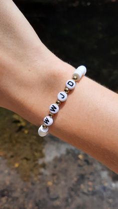 a person's arm with a bracelet that says, i love you on it