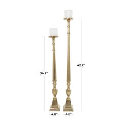 two tall brass candlesticks are shown with the measurements for each candle and size