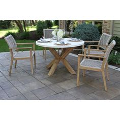 an outdoor table with four chairs around it