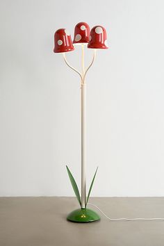 three red and white lamps sitting on top of a table