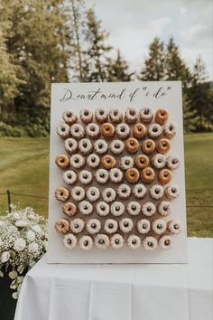 a card with donuts on it sitting on top of a table next to flowers