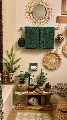 a bathroom with plants and towels hanging on the wall