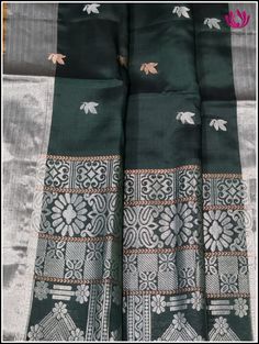 This is a beautiful Dark green,elegant soft saree with silver bavanchi border. The body of the saree is in dark green woven with a floral design in silver and copper zari. The pallu is grand with heavy silver zari work. Hand made tassels adds beauty. This saree comes with an unstitched contrast golden green double shaded blouse piece. A pretty saree perfect for any occasion. Handmade tassels Edging done on the other side Blouse - unstitched Please note: Color may vary slightly from the picture. Silver Raw Silk Saree With Zari Work, Silver Chanderi Saree With Zari Work, Silver Silk Saree With Cutdana, Festival Raw Silk Silver Saree, Silver Saree With Cutdana, Silver Raw Silk Saree For Festivals, Festival Silver Raw Silk Saree, Silver Silk Saree Traditional Wear, Silver Silk Saree For Festivals