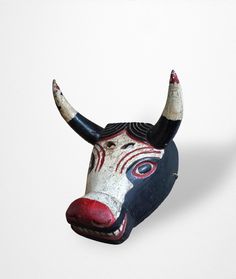 An extremely well executed Torito mask in original surface. The maker's sense of humor is evident in the bull's sly smile and blood stained horns. Guatemala, Circa 1930-50 Height  7.5" Width  8.5" Depth  8" Sly Smile, Costume Masks, Costume Mask, Sense Of Humor, Guatemala, Costume Accessories, Sense, Mask, Humor