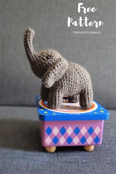 a knitted elephant sitting on top of a toy box with the words free pattern above it