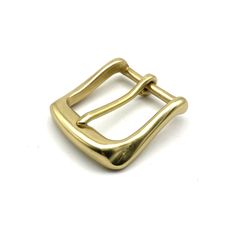 a gold buckle on a white background