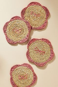 three woven coasters with monogram on them sitting on top of a white table