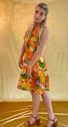 A Bright orange/yellow/green 60s printed chiffon sleeveless dress. The ideal festival/wedding halter neck dress. It's Shown on a Medium sized model. Chest measures 35 inches and total length is 36 inches. In good vintage condition. Orange Halter Neck Sleeveless Dress For Summer, Yellow Floral Print Sleeveless Party Dress, Orange Summer Halter Neck Dress, Orange Halter Neck Dress For Summer, Vintage Orange A-line Dress, Orange Retro Print Summer Dress, Mod Summer Beach Dresses, Summer Mod Beach Dresses, Retro Halter Neck Summer Dress