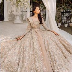 a woman in a wedding dress sitting on the ground