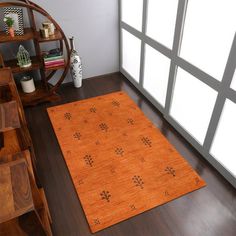 an orange area rug on a wooden floor