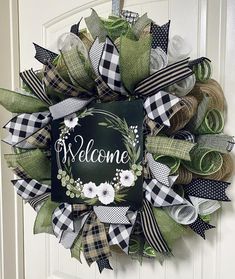 a welcome wreath hanging on the front door