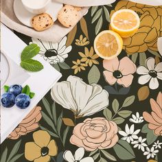 a table topped with blueberries, oranges and cookies