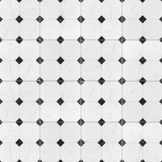 a white and black tiled wall with diamond shapes