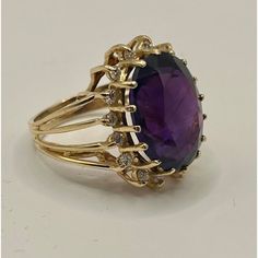 This is part of Chairish’s Fine Jewelry assortment.  14k yellow gold cocktail ring featuring a deep purple/red/blue oval amethyst, encircled by 16 small diamonds.  Ring Size: 6 in. Stone: 16.42 x 12.40 x 8.7 mm Ring Weight: 6.7 grams  If you would like more information, please contact me via email, mrboult@gmail.com. Purple Gemstone Ring, Yellow Gold Cocktail Ring, Green Pendant, Amethyst And Diamond Ring, Green Pendants, Gold Cocktail Ring, Gold Cocktail, Diamonds Ring, Diamond Cocktail Rings