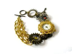 This beautiful steampunk watch bracelet is a unique art piece for the purveyor of eclectic and  sophisticated hand-crafted artisan jewelry. Steampunk is a unique style that combines the  Victorian look with a cog and steam powered industrial revolution look. The effect is certainly  unique and eye-catching.  Gears, cogs, watch parts and Swarovski crystals make this chunky bracelet a wondrous thing.  Surrealism meets realism in this esoteric world of tech. Steampunk jewelry is an impressive  phen Handmade Steampunk Bracelets As Gift, Handmade Steampunk Bracelets For Gift, Steampunk Gold Watch As Gift, Gold Steampunk Style Watch As Gift, Steampunk Silver Bracelet As Gift, Gold Steampunk Watch As Gift, Gold Steampunk Watch For Gift, Silver Steampunk Bracelet As Gift, Silver Steampunk Bracelet For Gift