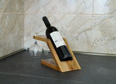 a bottle of wine sitting on top of a wooden stand