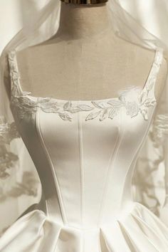 a white wedding dress on a mannequin