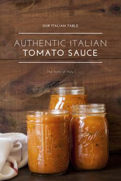 three jars filled with tomato sauce sitting on top of a table