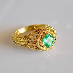 Exquisite geometric avant garde 18k solid Gold Emerald Ring. Material: 18k solid Gold Stone: Pristine AAA+ grade natural Columbian Emerald All our Stones are Ethically sourced. Made with Love at our Temple Jewels studio in ibiza. Custom orders Welcomed! Free world wide shipping. Sizing included For more rings: https://www.etsy.com/shop/templejewelsibiza/items?section_id=21449468 To my shop: https://www.etsy.com/shop/templejewelsibiza Exquisite 14k Gold Emerald Ring, Antique 14k Gold Emerald Ring, Elegant 14k Gold Multi-stone Emerald Ring, 14k Gold Emerald Ring With 17 Jewels - Collectible, 14k Gold Green Emerald Ring, Fine Jewelry, Gold Emerald Ring, New Saree Blouse Designs, Columbian Emeralds, Emerald Ring Gold