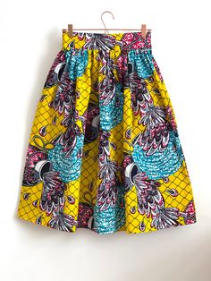 "Multicolour African high waist full gathered skirt. Perfect for casual outfits and special ocasions with pair of trainers or high heels. Skirt with elastic at the back of waist.  Two side pockets. Midi length skirt about 70 cm  + 5 cm waistband. Handmade in UK.  HOW TO CHOOSE A SIZE ?   Using a measuring tape, measure the smallest part of your waist.  SIZE CHART: (CM) XS - W: 66 CM S - W: 70 CM M - W: 74 CM  L - W: 78 CM  XL - W: 82 CM  CARE INSTRUCTIONS: Hand wash only, do not bleach, hang dry, do not tumble dry, press with a cool iron on the reverse side.  Please message me before purchasing so I can check availability. If you wish this skirt set in any other fabric, shorter or longer \"send message to seller\".  *Depends on computer/monitor settings colours might be different." Multicolor Pleated Flared Skirt, Multicolor Full Skirt Dress With Gathered Detail, Multicolor Full Dress With Gathered Skirt, Multicolor Relaxed Skirt With Elastic Waistband, Multicolor Relaxed Fit Skirt With Elastic Waistband, Multicolor Gathered Skirt Dress For Spring, Multicolor Cotton Knee-length Skirt, Multicolor Knee-length Cotton Skirt, Multicolor Midi Skirt With Elastic Waistband