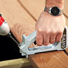 a person using a power tool on a piece of wood