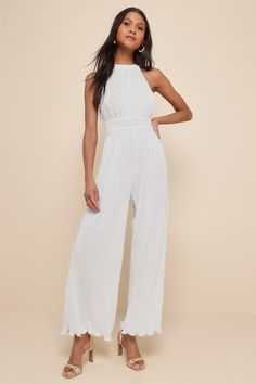 Shake up your event-ready looks with a picture-perfect outfit like the Lulus Flawless Mindset Ivory Satin Plisse Tie-Back Jumpsuit! Plisse-pleated woven satin shapes this elevated jumpsuit with a modified halter neckline (with back loop-button closures) and a fitted bodice with a smocked, banded waist. Relaxed, wide pant legs end at full length hems. Turn around to reveal a back cutout with a tying sash bow for an extra-femme finish! Elastic at back. Fit: This garment fits true to size. Length: Elegant Halter Neck Jumpsuits And Rompers For Formal Occasions, Elegant Formal Halter Neck Jumpsuits And Rompers, Elegant Formal Halter Neck Jumpsuits, Formal Sleeveless Jumpsuits And Rompers For Summer, Sleeveless Jumpsuits And Rompers For Formal Summer Events, Chic White Halter Neck Jumpsuits And Rompers, Elegant Summer Jumpsuits And Rompers For Wedding Guests, Sleeveless Jumpsuits And Rompers For Wedding Guests In Summer, Spring Wedding Fitted Jumpsuits And Rompers