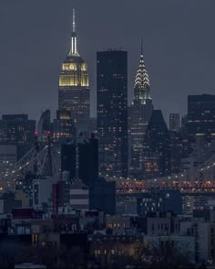 the city skyline is lit up at night