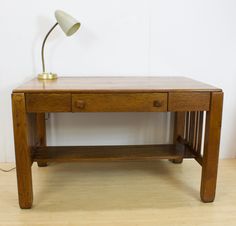 a wooden desk with a lamp on top