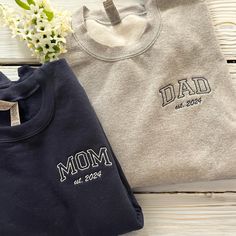 best gifts for mom, baby announcement, gift for grandma, christmas gift, mothers day, gift for mom, mom sweatshirt, mama sweatshirt, grandma sweatshirt, embroidered gift, new mom PRODUCT AND BRAND DETAILS ➤ Gildan ® brand ➤ Unisex & Classic fit ➤ 8 oz./yd² (US) 13.3 oz./L yd (CA), 50/50 cotton/polyester, 20 singles - Heather Sport colors are 60/40 polyester/cotton PERSONALIZED GUIDE: Custom sweatshirts, hoodies, and tees will usually have four embroidery positions: ➤On the chest: Left chest (above the heart), right chest, middle chest. ➤On the sleeve: Left sleeve or right sleeve (you can customize both, one side is free). ➤On the back of the shirt: In the middle. ➤In the hood for hoodies. If you want to embroider any of these positions, please place an order and let us know in the Personal Mom And Dad Sweatshirts, Gift For New Dad, Custom Embroidered Sweatshirt, Mom Dad Baby, New Dad Gift, Best Gifts For Mom, Embroidered Gifts, Mama Shirts, Gifts For New Dads