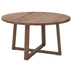 a round wooden table with two crossed legs