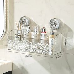 a bathroom shelf with three bottles and two soap dispensers on it next to a window