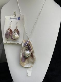 "Natural sea shell pendant necklace, ocean shells clustered with all different types of shells finished with a Sterling plated Sea shell locket pendant with matching earrings with Sterling plated shells also. Includes Sterling plated earring hoops.  On a Sterling silver plated 20\" cable chain. Unique seashell pendant measures 3 1/4\" X 1 3/4'' Earrings are 2 1/8 from the lob part of the hook.  You can compare the size of the shells to the $0.50 cent piece in the pictures. All my necklaces are d Shell Jewelry With Pearl Pendant, Ocean-inspired Dangle Charms Jewelry, Silver Shell-shaped Ocean-inspired Jewelry, Ocean-inspired Charms For Jewelry Making, Ocean-inspired Silver Charms Jewelry, Adjustable Ocean-inspired Metal Jewelry, Shell-shaped Jewelry With Pearl Pendant, Shell-shaped Pearl Pendant Jewelry, Ocean-inspired Shell-shaped Pearl Pendant Jewelry