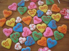 heart shaped cookies with words on them are arranged in the shape of letters and hearts