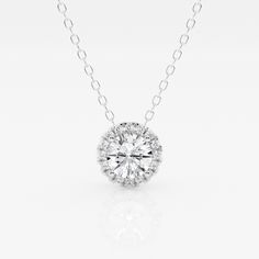 A diamond with a fine halo is better than none! This beautiful round lab grown diamond pendant is encircled with tiny shimmering smaller diamonds, to create a halo effect. Suspended by a delicate gold chain that slides through. Luxury Diamond Necklace With Round Pendant And Cable Chain, Anniversary Halo Solitaire Necklace In Cubic Zirconia, Anniversary Halo Solitaire Cubic Zirconia Necklace, Cubic Zirconia Solitaire Necklace With Halo Design For Anniversary, Sterling Silver Diamond White Necklace With Halo Design, Dazzling Cubic Zirconia Diamond Necklace With Halo Design, White Solitaire Necklace With Halo Design In Sterling Silver, White Sterling Silver Solitaire Necklace With Halo Design, Diamond White Solitaire Necklace With Halo Design