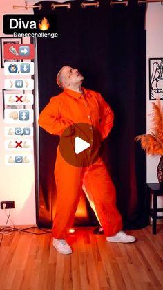 a man in an orange jumpsuit is standing on a wooden floor and has his eyes closed