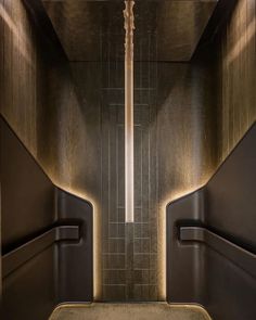 the interior of a bathroom with two urinals