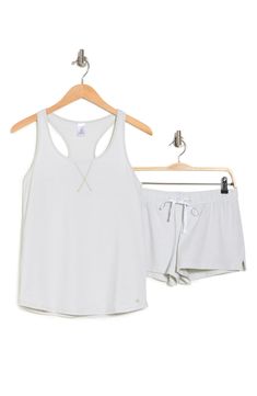 Get cozy for bedtime with this logo printed 2-piece pajama set from Calvin Klein. 27" length top; 6" rise, 3" inseam shorts (size S) Top has scoop neck; racerback Bottoms have elastic drawstring waist 95% cotton, 5% elastane Machine wash Imported Model's stats for sizing: - Height: 5'10" - Bust: 34" - Waist: 24.5" - Hips: 34" Model is wearing size S. Summer Athleisure Activewear For Loungewear, Comfortable Tank Top For Loungewear, Sleeveless Moisture-wicking Activewear For Loungewear, Moisture-wicking Sleeveless Activewear, Sleeveless Cotton Activewear For Loungewear, Comfortable Summer Activewear For Loungewear, Athleisure Crew Neck Tank Top For Loungewear, Casual Short Tank Top For Loungewear, Casual Stretch Short Set For Loungewear