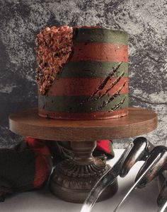 there is a cake that has been decorated with red and green stripes on the top