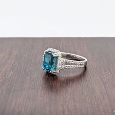 Blue Emerald Cut Diamond Ring, Blue Baguette Cut Diamond Ring, Blue Radiant Cut Diamond Accented Jewelry, Baguette Cut Topaz Ring With Diamond Halo Setting, Baguette Cut Topaz Ring With Diamond Halo, Blue Diamond Ring With Diamond Accents Emerald Cut, Blue Emerald Cut Diamond Ring With Accents, Blue Emerald Cut Diamond Ring With Diamond Accents, Blue Emerald Cut Diamond Ring With Halo Setting